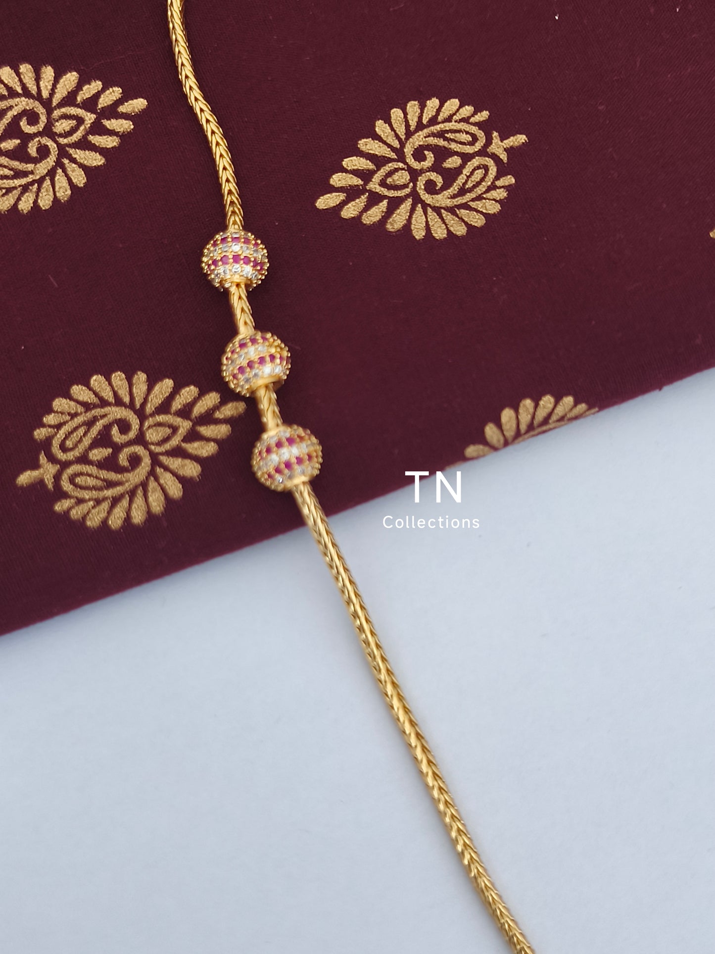 Gold plated Traditional Mugappu Kodi (Ruby & White stones)