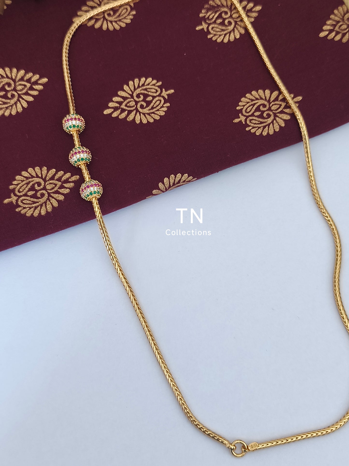 Gold plated Traditional Mugappu Kodi (Ruby,White & Green stones)