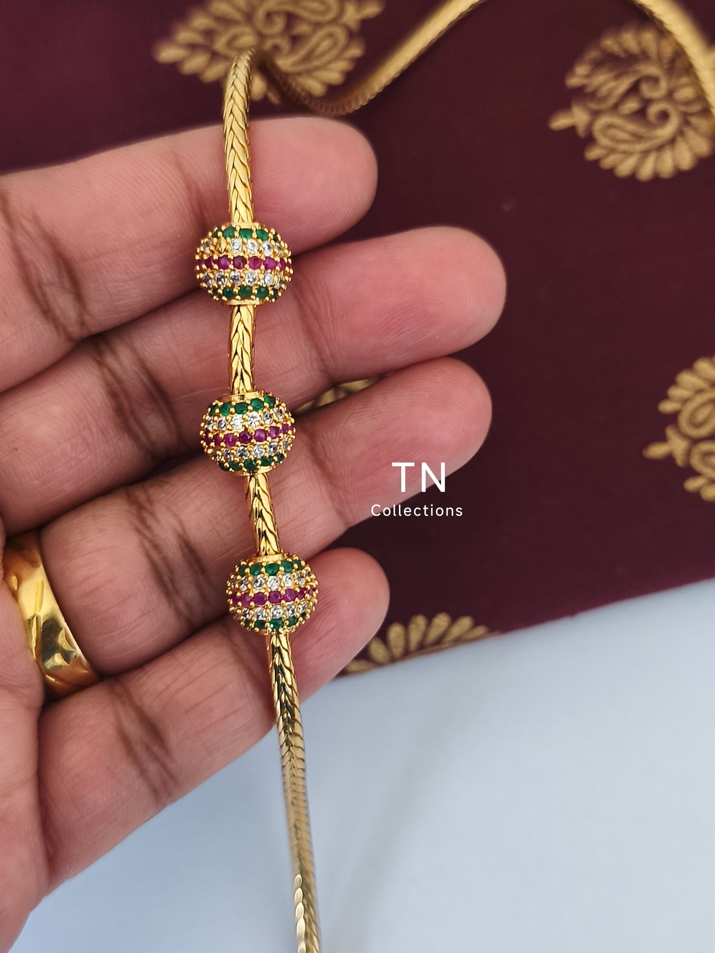 Gold plated Traditional Mugappu Kodi (Ruby,White & Green stones)