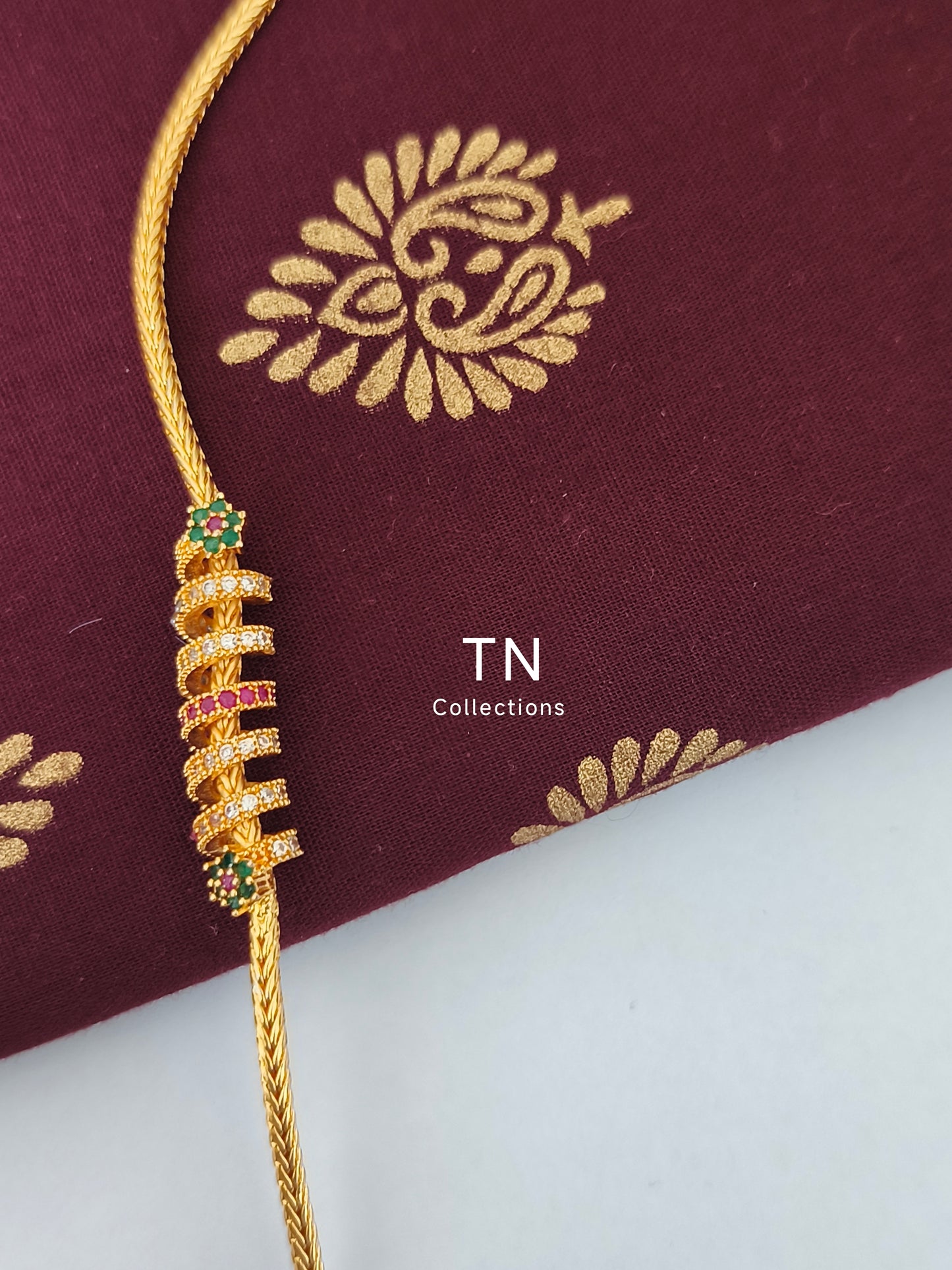 Micro gold plated Traditional Mugappu Kodi (White, Ruby & Green stone)