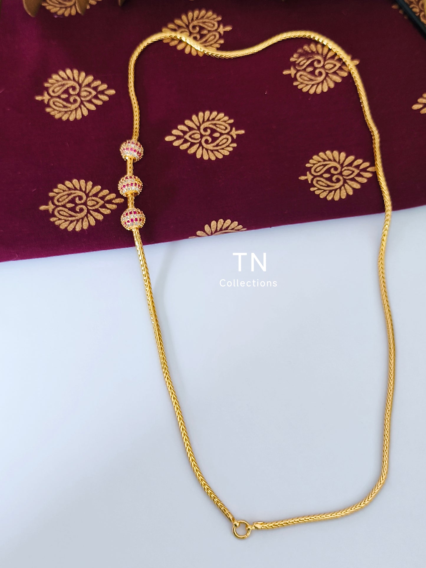 Gold plated Traditional Mugappu Kodi (Ruby & White stones)