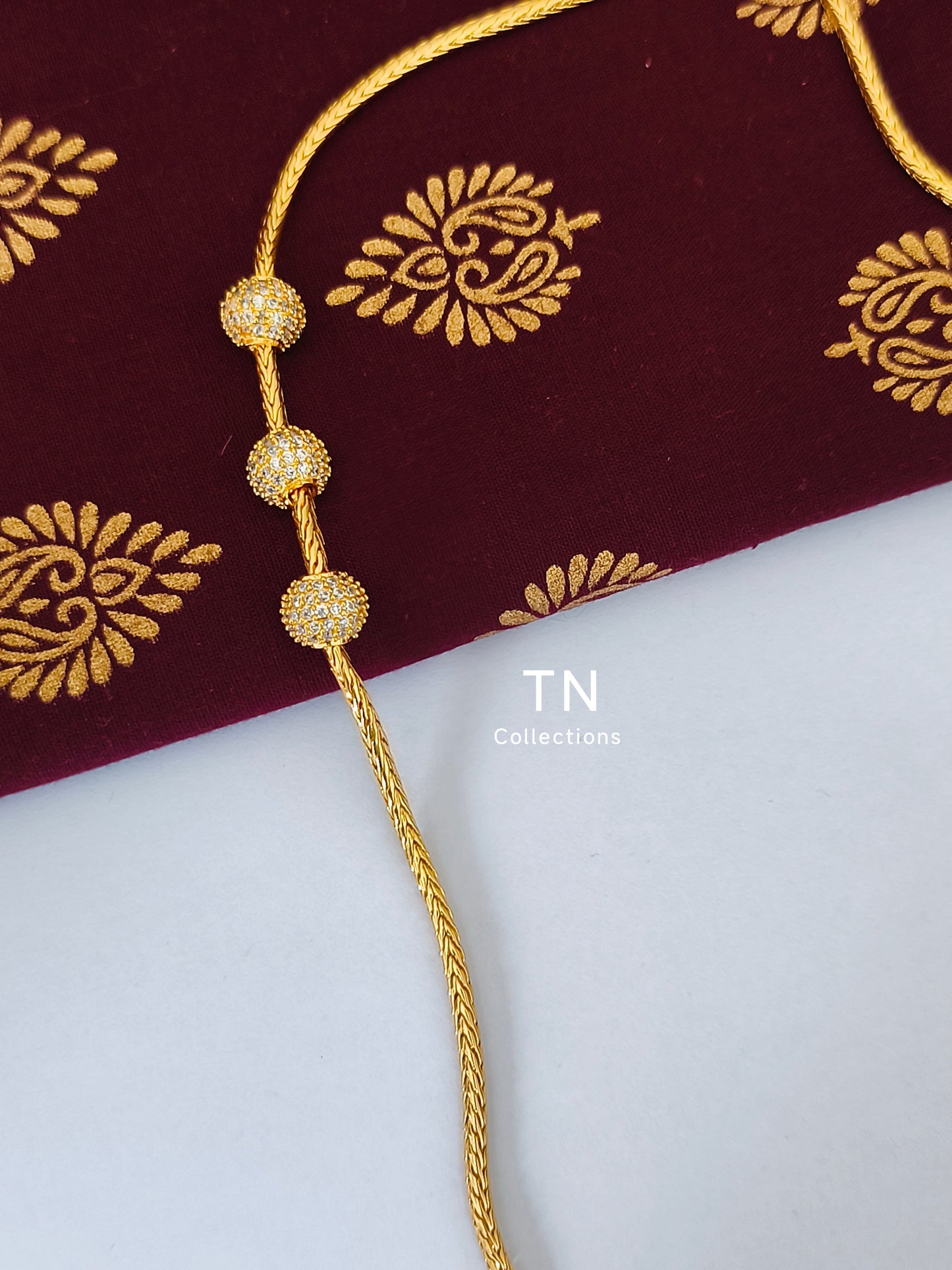 Gold plated Traditional Mugappu Kodi (white stone)