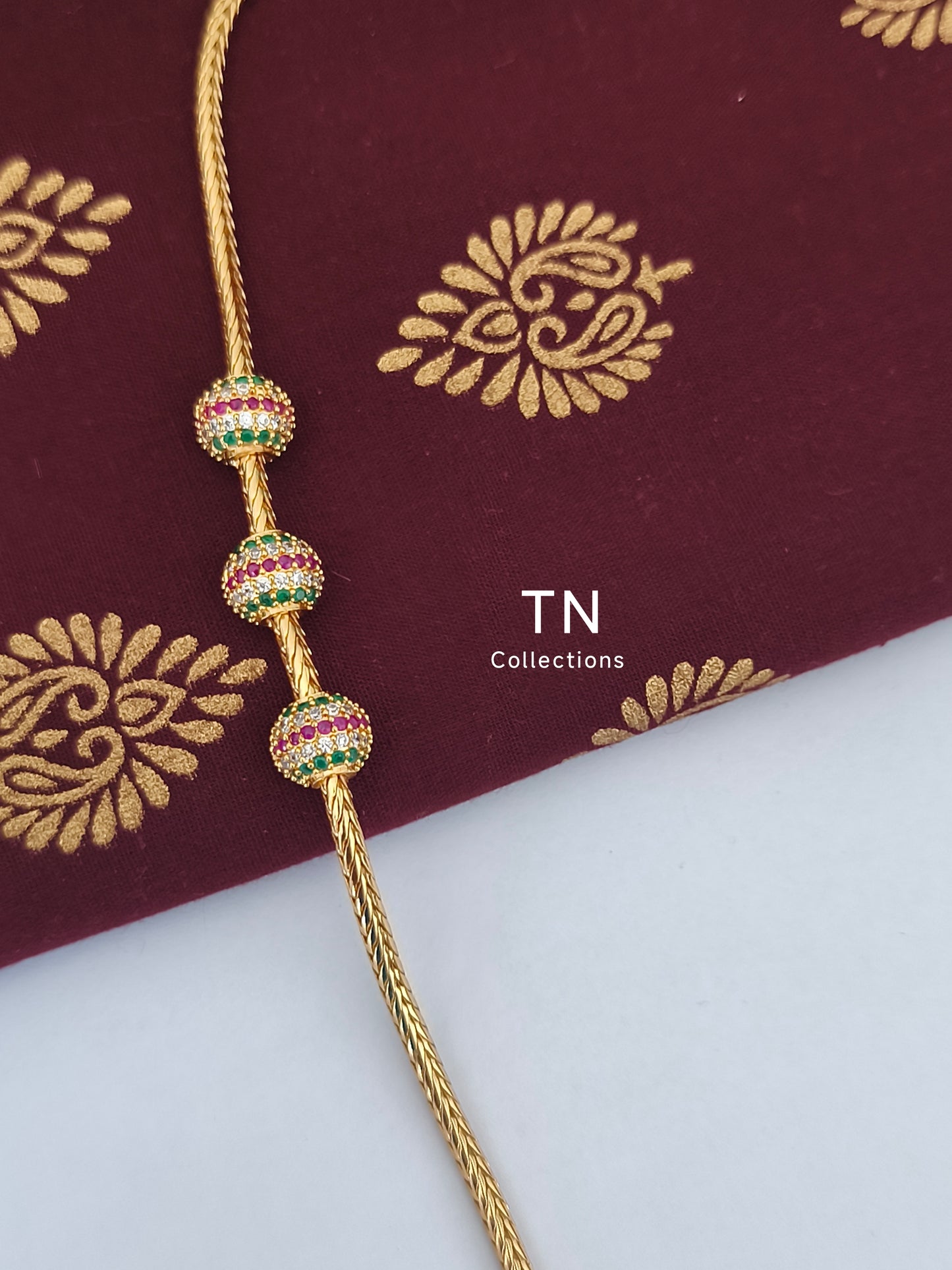 Gold plated Traditional Mugappu Kodi (Ruby,White & Green stones)